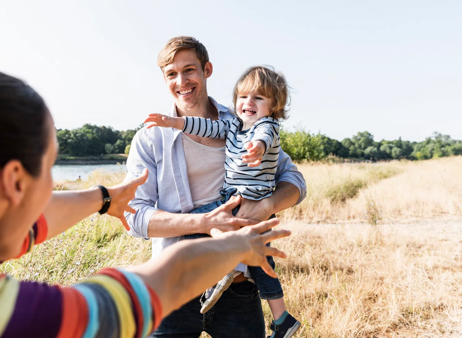 happy-family-walking-at-the-riverside-on-a-beautif-2024-09-20-16-15-52-utc